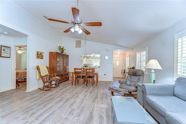 5906 Greenbriar Ct, Zephyrhills, FL 33542 - living area with light wood-style flooring, ceiling fan, vaulted ceiling, and baseboards