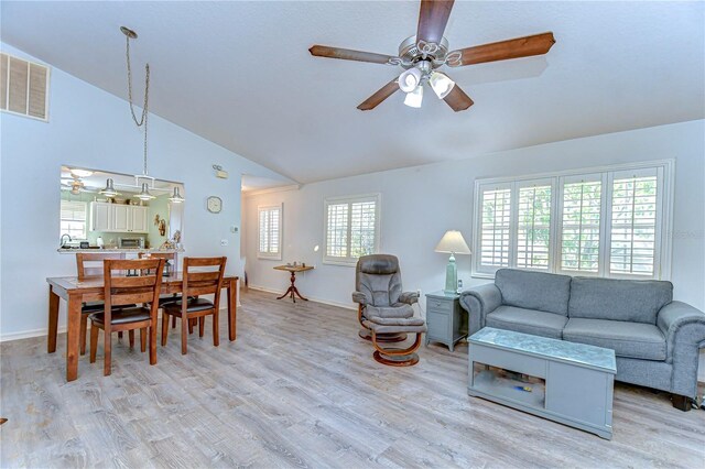 5906 Greenbriar Ct, Zephyrhills, FL 33542 - living area with visible vents, baseboards, light wood-type flooring, a ceiling fan, and high vaulted ceiling