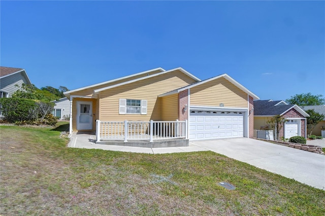 5906 Greenbriar Ct, Zephyrhills, FL 33542 - ranch-style home featuring concrete driveway, an attached garage, a front yard, a porch, and brick siding