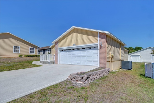 5906 Greenbriar Ct, Zephyrhills, FL 33542 - view of front of house with an attached garage, driveway, a front yard, and central AC