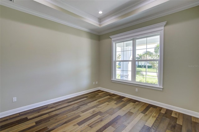 empty room featuring crown molding, baseboards, dark wood-style floors, a tray ceiling, and recessed lighting