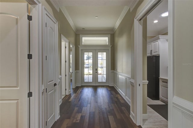 entryway with french doors, crown molding, a wainscoted wall, and dark wood-style floors