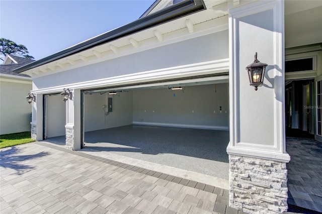 garage with decorative driveway