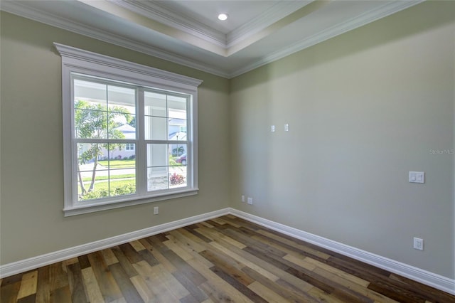 unfurnished room with baseboards, a raised ceiling, ornamental molding, recessed lighting, and dark wood-type flooring
