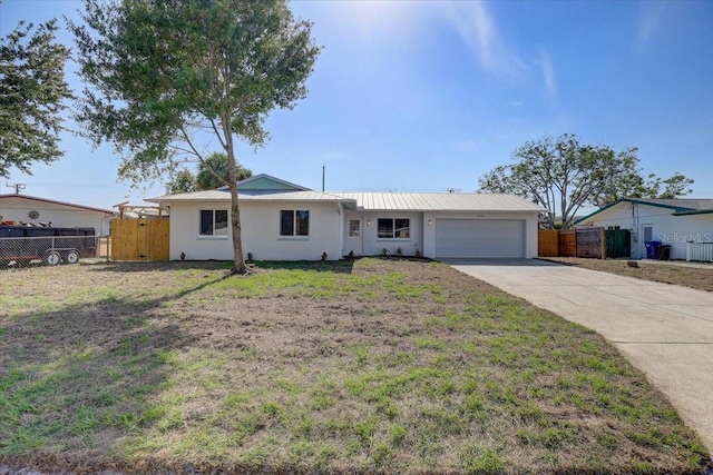 3404 33rd Street Ct W, Bradenton, FL 34205 - ranch-style house with a garage, driveway, metal roof, and stucco siding