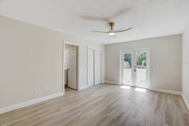 3404 33rd Street Ct W, Bradenton, FL 34205 - empty room with french doors, ceiling fan, light wood finished floors, baseboards, and a textured ceiling