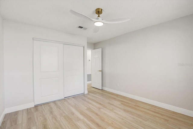 3404 33rd Street Ct W, Bradenton, FL 34205 - unfurnished bedroom with light wood-style floors, baseboards, a closet, and a ceiling fan