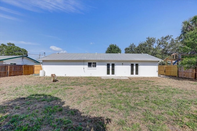 3404 33rd Street Ct W, Bradenton, FL 34205 - rear view of house featuring french doors, stucco siding, and metal roof