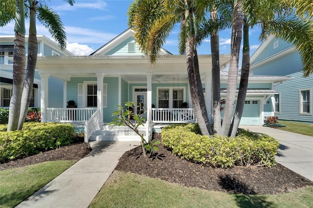 view of front of property featuring an attached garage, covered porch, and driveway
