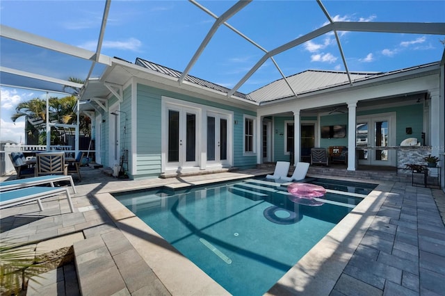 rear view of property featuring a patio area, french doors, and metal roof