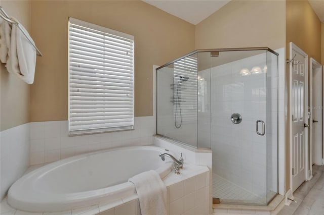 full bath featuring a bath and a stall shower