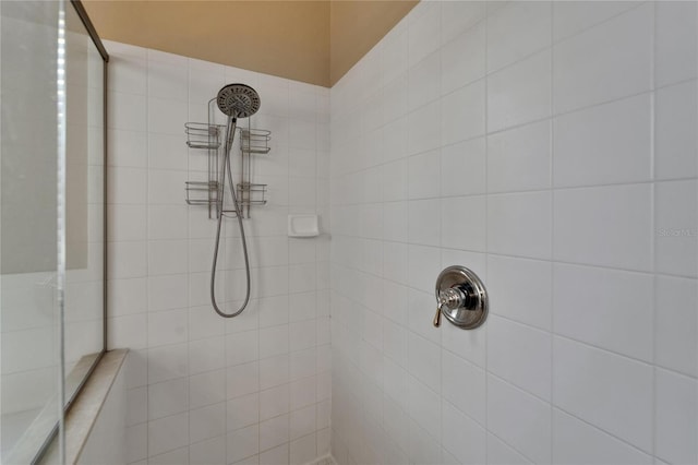 bathroom with a tile shower