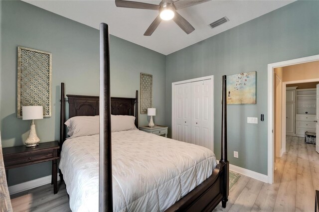 bedroom featuring a closet, light wood-style flooring, baseboards, and visible vents