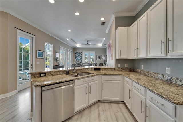 kitchen with light wood-type flooring, crown molding, visible vents, dishwasher, and a sink