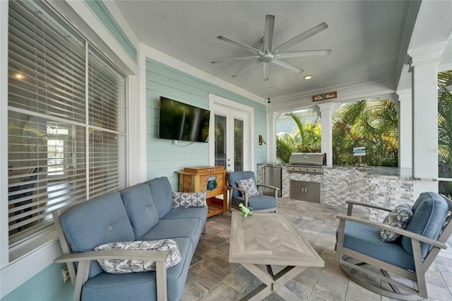 view of patio featuring exterior kitchen, an outdoor living space, french doors, a ceiling fan, and area for grilling