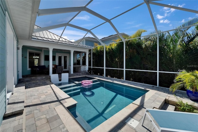view of pool with a patio area, french doors, and glass enclosure