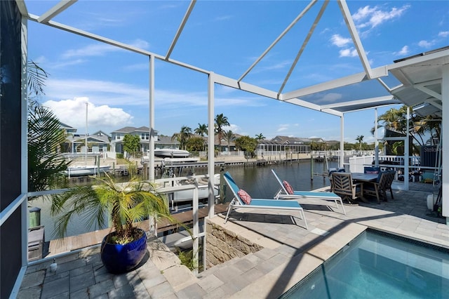 dock area featuring boat lift, a patio area, a water view, and glass enclosure