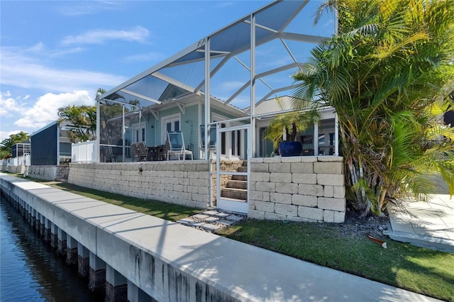 view of property exterior featuring glass enclosure and fence