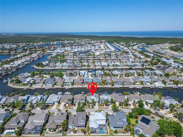 drone / aerial view with a residential view and a water view