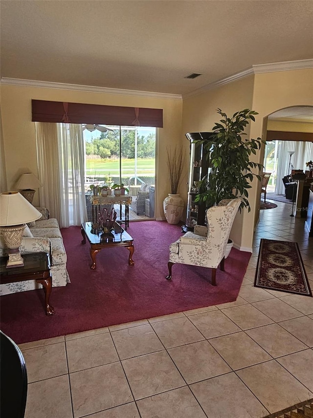 522 Planters Manor Way, Bradenton, FL 34212 - carpeted living area with arched walkways, tile patterned flooring, plenty of natural light, and crown molding