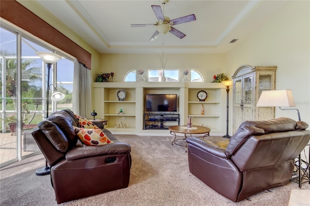 522 Planters Manor Way, Bradenton, FL 34212 - carpeted living room with a ceiling fan, a tray ceiling, and built in features