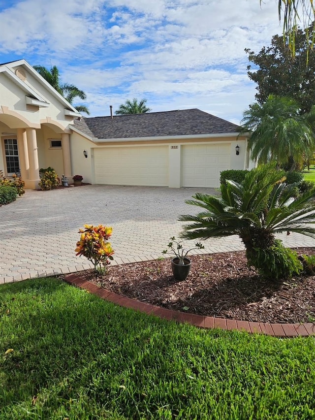 522 Planters Manor Way, Bradenton, FL 34212 - view of property exterior featuring stucco siding, a garage, and decorative driveway