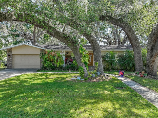 view of front of house featuring a garage, driveway, a front lawn, and stucco siding