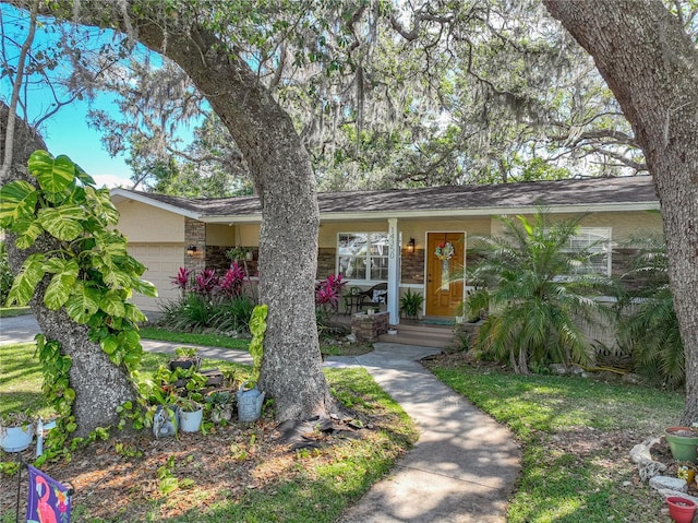 view of front of house featuring a porch and a garage