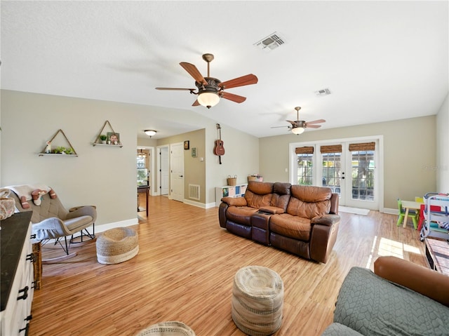 living area featuring a ceiling fan, light wood finished floors, and visible vents