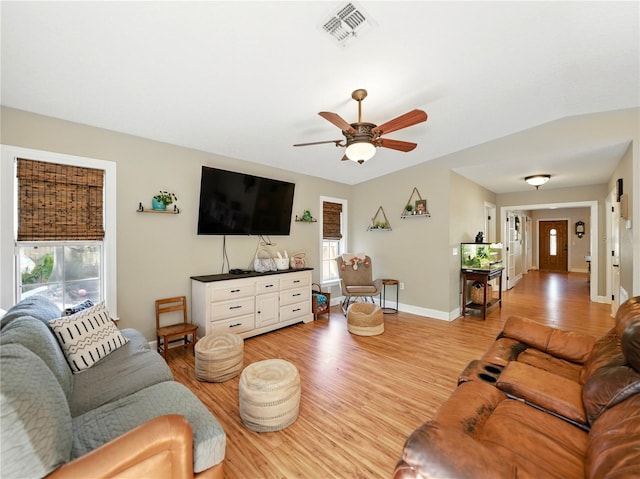 living area with ceiling fan, baseboards, visible vents, and light wood-type flooring