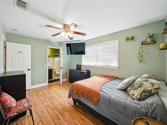 bedroom with visible vents, a ceiling fan, connected bathroom, light wood-type flooring, and baseboards
