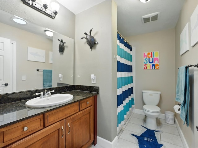 bathroom featuring tile patterned floors, vanity, baseboards, toilet, and visible vents