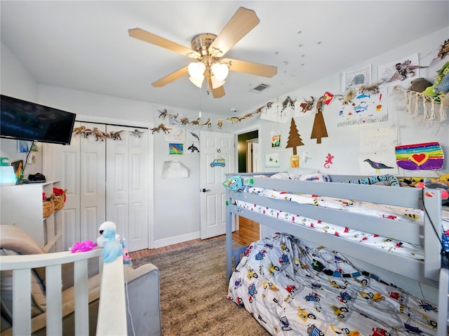 bedroom with visible vents, wood finished floors, a closet, and ceiling fan
