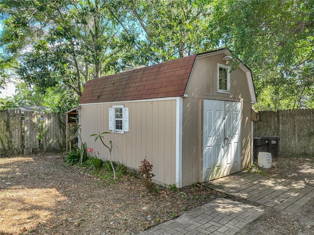 view of shed featuring fence