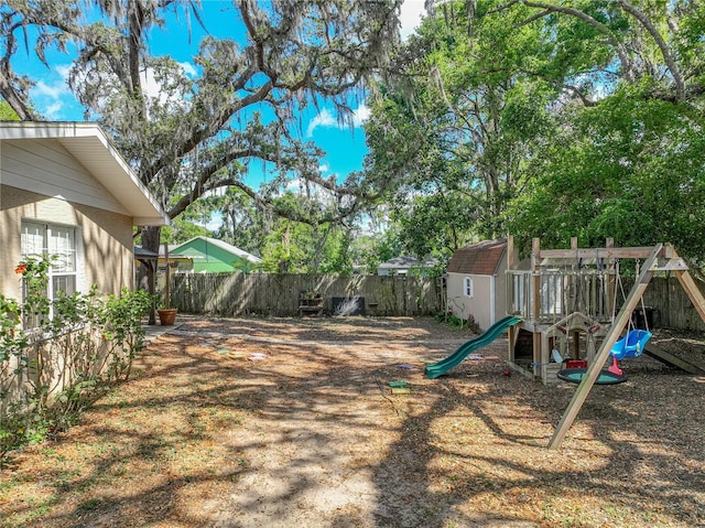 view of yard featuring fence and a playground