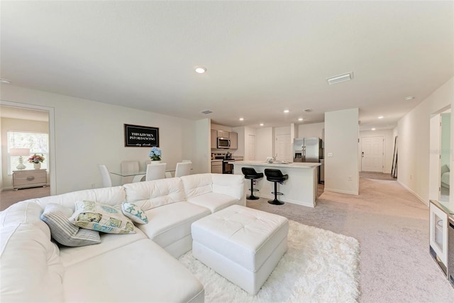 3879 E Price Blvd, North Port, FL 34288 - living area with light carpet, recessed lighting, visible vents, and baseboards