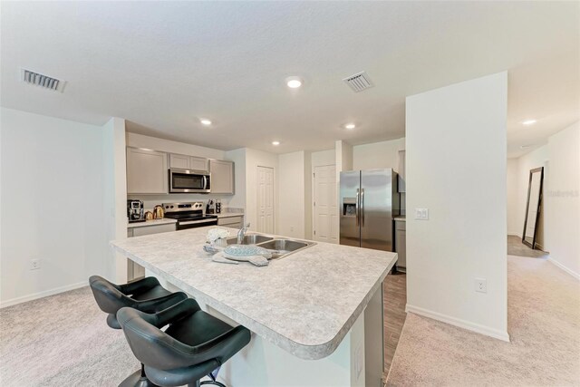 3879 E Price Blvd, North Port, FL 34288 - kitchen with visible vents, appliances with stainless steel finishes, light countertops, a sink, and gray cabinetry