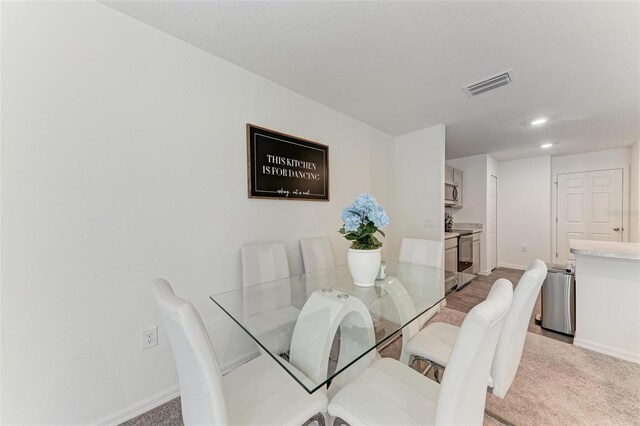3879 E Price Blvd, North Port, FL 34288 - dining room featuring light carpet, baseboards, visible vents, and recessed lighting