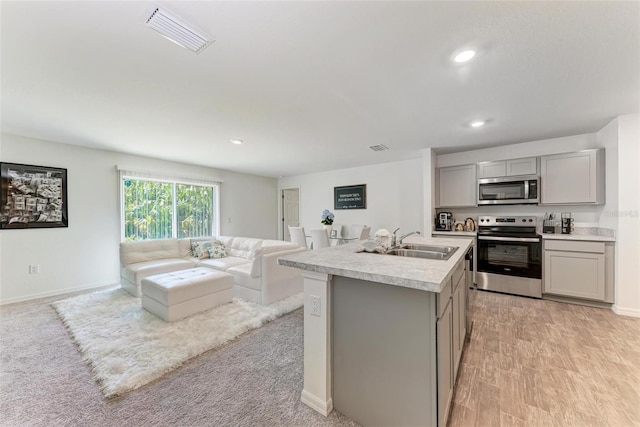3879 E Price Blvd, North Port, FL 34288 - kitchen with gray cabinets, open floor plan, visible vents, stainless steel appliances, and a sink