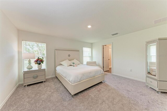 3879 E Price Blvd, North Port, FL 34288 - bedroom with baseboards, visible vents, multiple windows, and light colored carpet