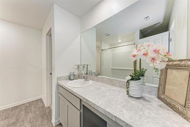 3879 E Price Blvd, North Port, FL 34288 - full bath with vanity, visible vents, baseboards, and wood finished floors