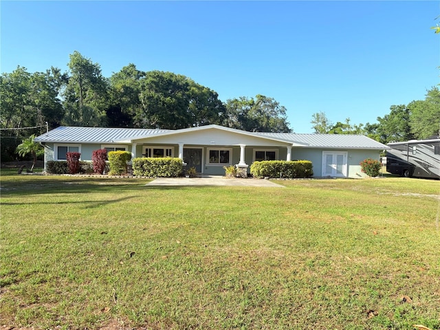 1203 Durant Rd, Brandon, FL 33511 - ranch-style house featuring a standing seam roof, a front yard, and metal roof