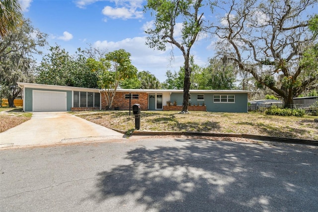 422 Dunedin Cir, Temple Terrace, FL 33617 - ranch-style home with concrete driveway, brick siding, and an attached garage