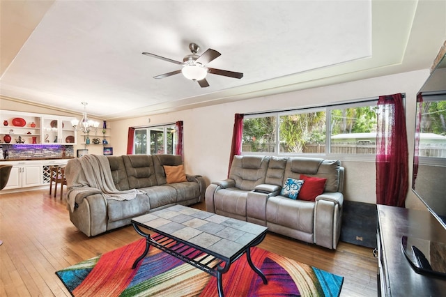 422 Dunedin Cir, Temple Terrace, FL 33617 - living area featuring ceiling fan with notable chandelier, a wealth of natural light, and hardwood / wood-style floors