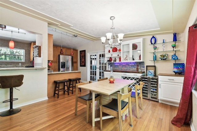 422 Dunedin Cir, Temple Terrace, FL 33617 - dining space with an inviting chandelier, french doors, light wood-style flooring, baseboards, and lofted ceiling