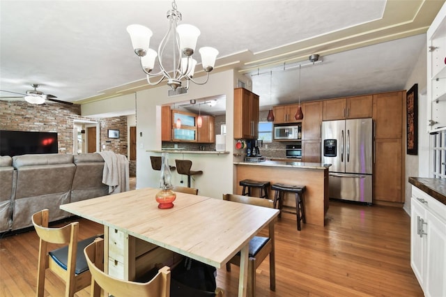 422 Dunedin Cir, Temple Terrace, FL 33617 - dining space featuring ceiling fan with notable chandelier and wood finished floors