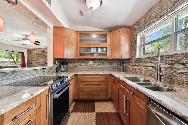 422 Dunedin Cir, Temple Terrace, FL 33617 - kitchen with decorative backsplash, wood finished floors, light stone countertops, a sink, and stainless steel appliances