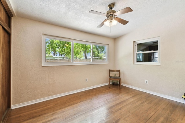 422 Dunedin Cir, Temple Terrace, FL 33617 - unfurnished bedroom with baseboards, a textured wall, and hardwood / wood-style flooring