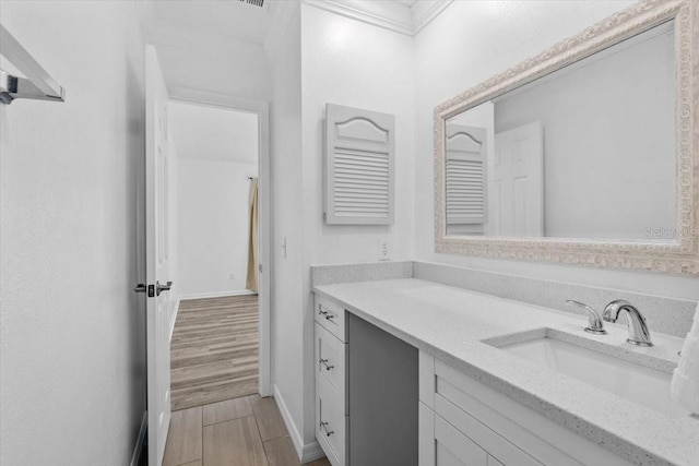 15118 Brushwood Dr, Tampa, FL 33624 - bathroom with vanity, wood finished floors, and baseboards