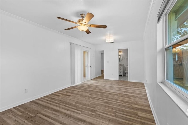 15118 Brushwood Dr, Tampa, FL 33624 - spare room featuring wood finished floors, a ceiling fan, baseboards, and ornamental molding